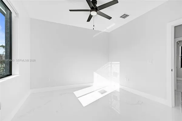 an aerial view of a house with a yard and potted plants