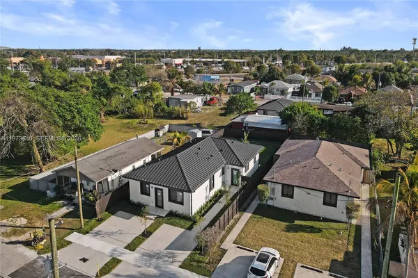 an aerial view of a house with a swimming pool