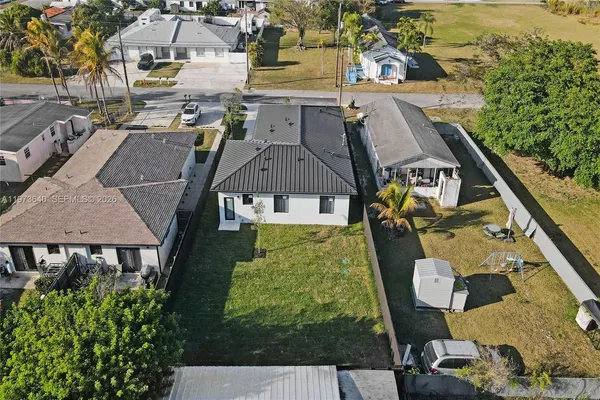 an aerial view of residential houses with outdoor space