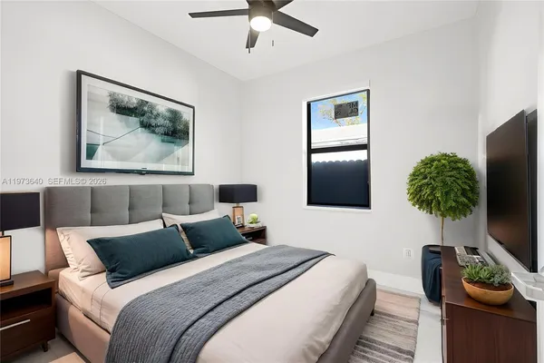 a bedroom with bed and a flat screen tv