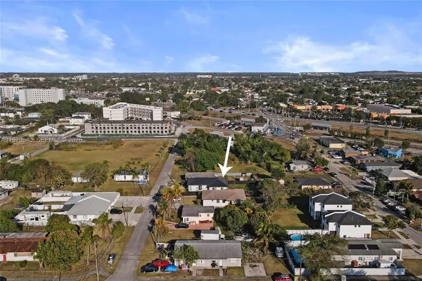 an aerial view of residential building with trees
