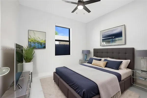 a bedroom with bed and a flat screen tv