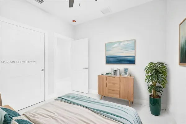 a bedroom with furniture and paintings on the wall