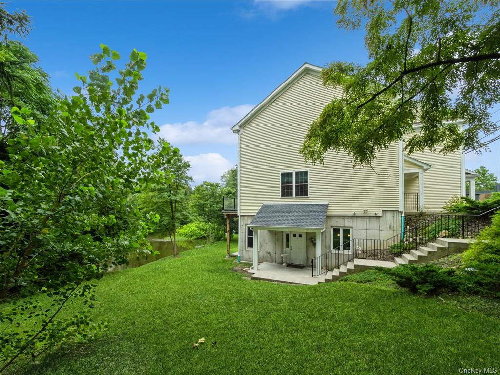 6-8 Wilbur Road Pleasant Valley, NY 12569 - Photo 2 of 36 Back of house featuring a lawn and a patio area