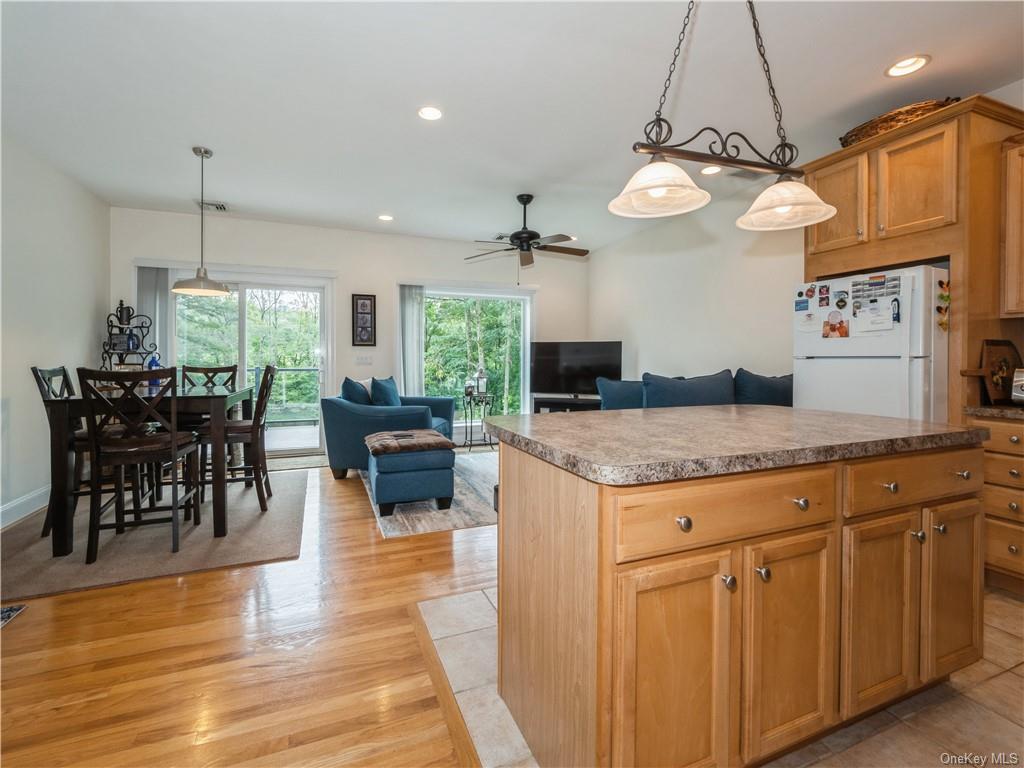 6-8 Wilbur Road Pleasant Valley, NY 12569 - Photo 22 of 36 Kitchen featuring ceiling fan, white fridge, a kitchen island, and light hardwood / wood-style floors
