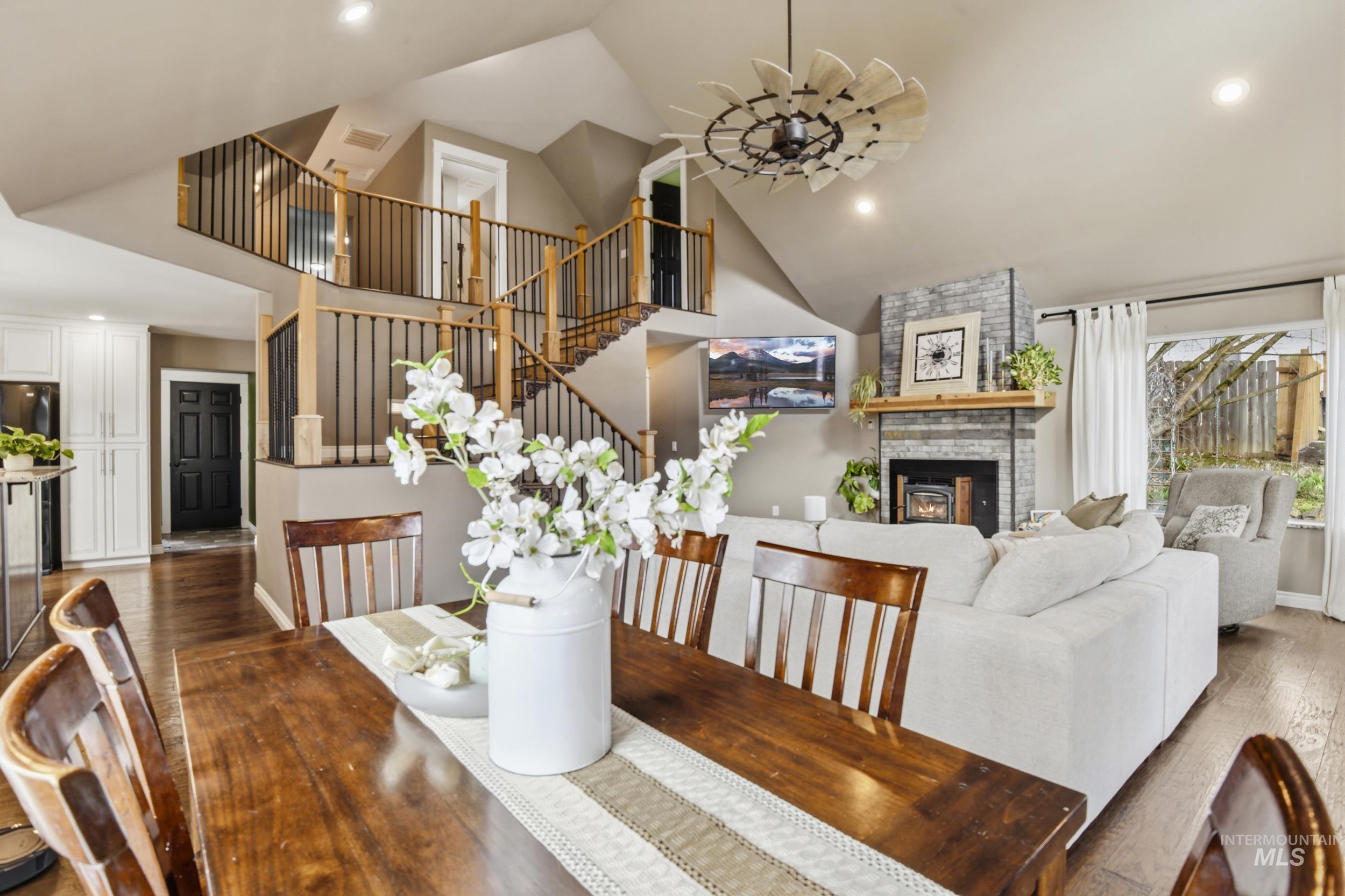 301 State Street Juliaetta, ID 83535 - Photo 14 of 41 Dining area with a ceiling fan, wood-type flooring, recessed lighting, a fireplace, and vaulted ceiling