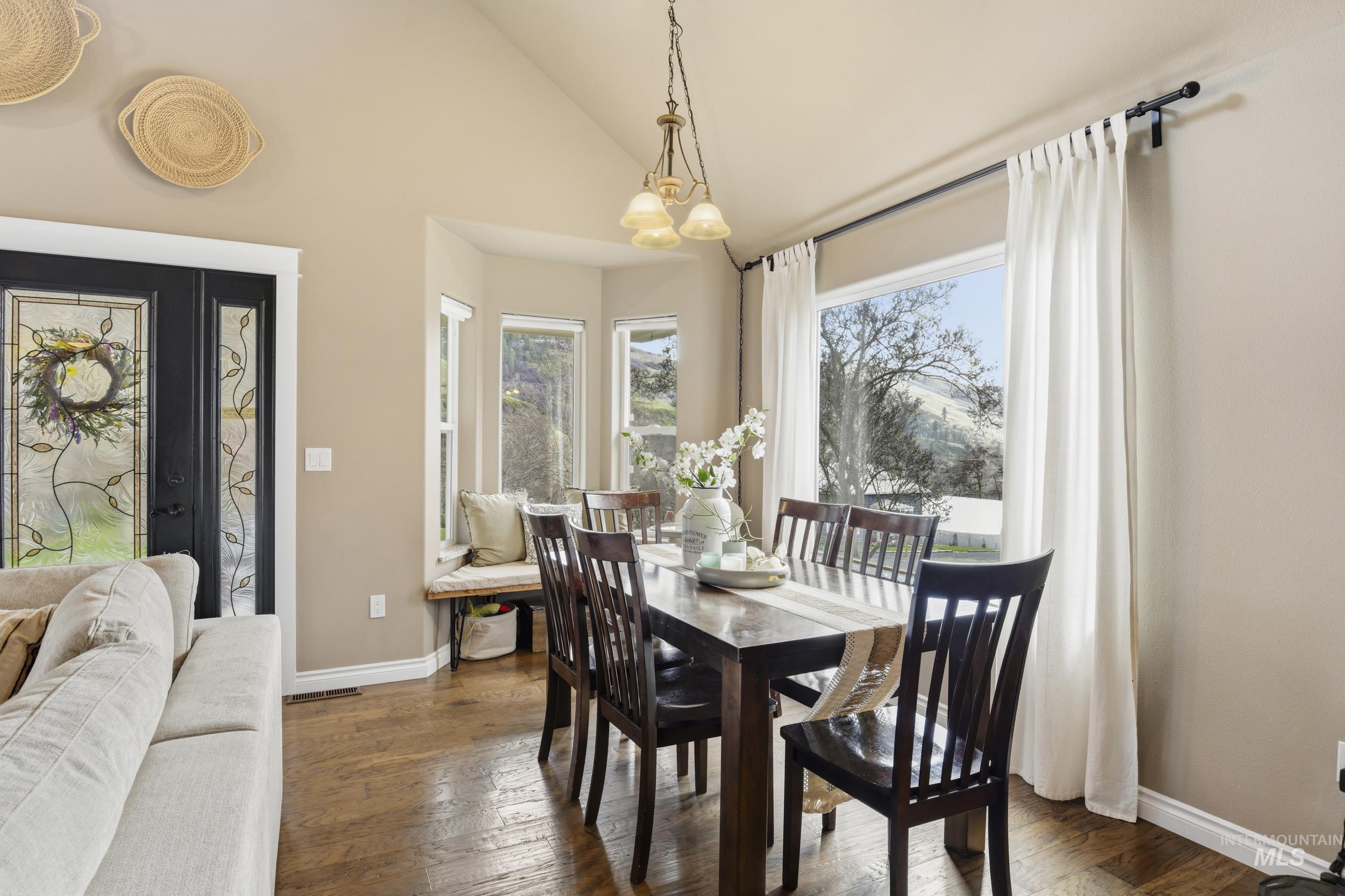 301 State Street Juliaetta, ID 83535 - Photo 15 of 41 Dining room with wood-type flooring, lofted ceiling, and suspended lighting
