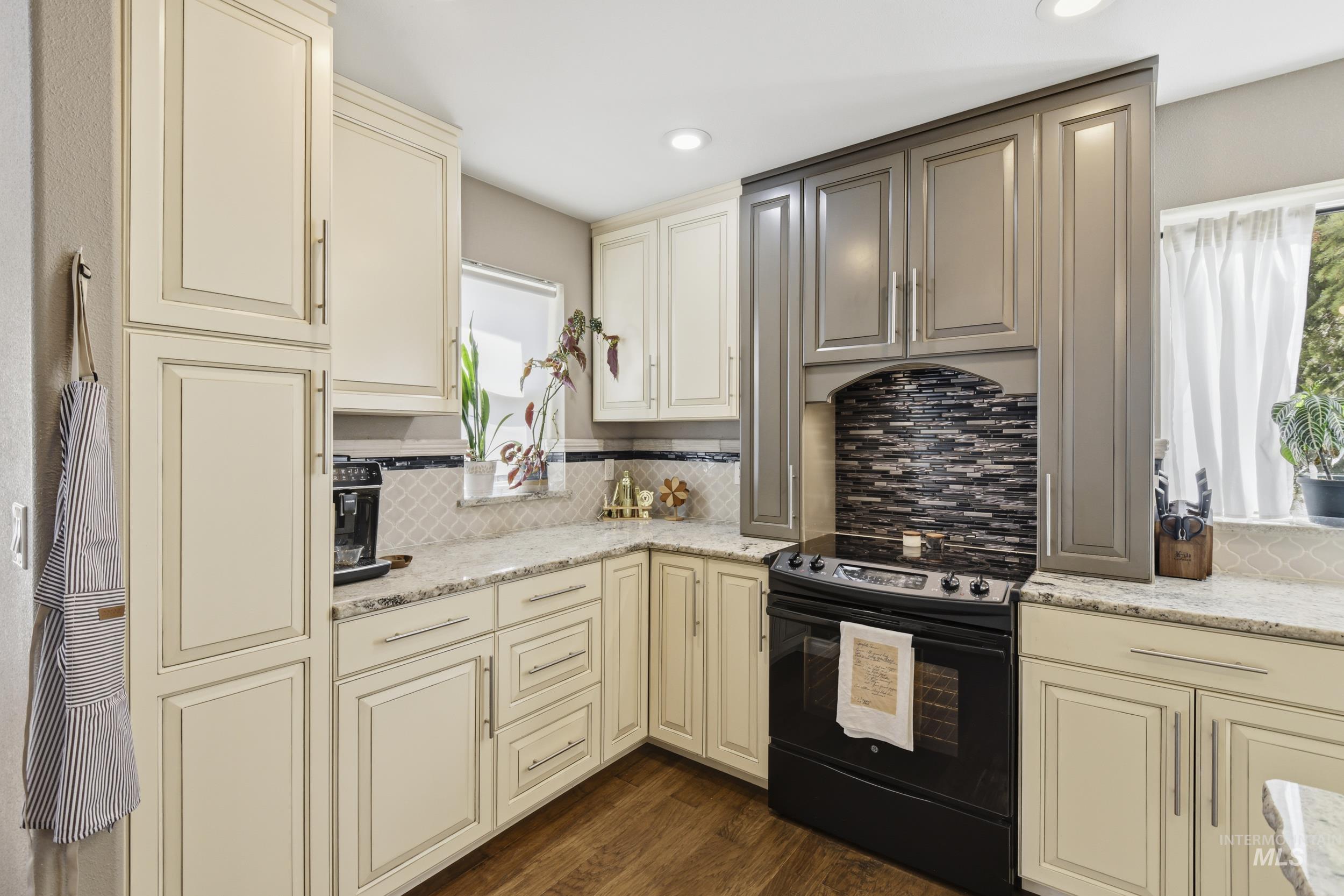 301 State Street Juliaetta, ID 83535 - Photo 18 of 41 Kitchen with cream cabinets, electric range, light stone counters, dark wood-style flooring, and recessed lighting