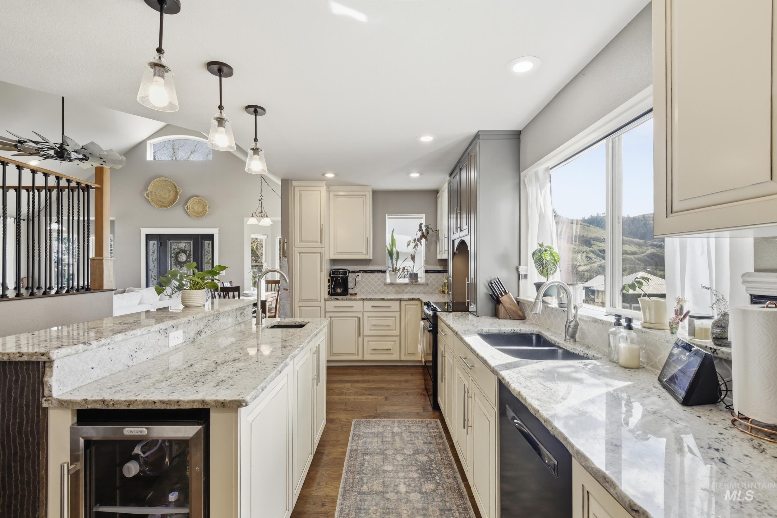 301 State Street Juliaetta, ID 83535 - Photo 20 of 41 Kitchen with wine cooler, cream cabinetry, light stone countertops, pendant lighting, and dishwasher