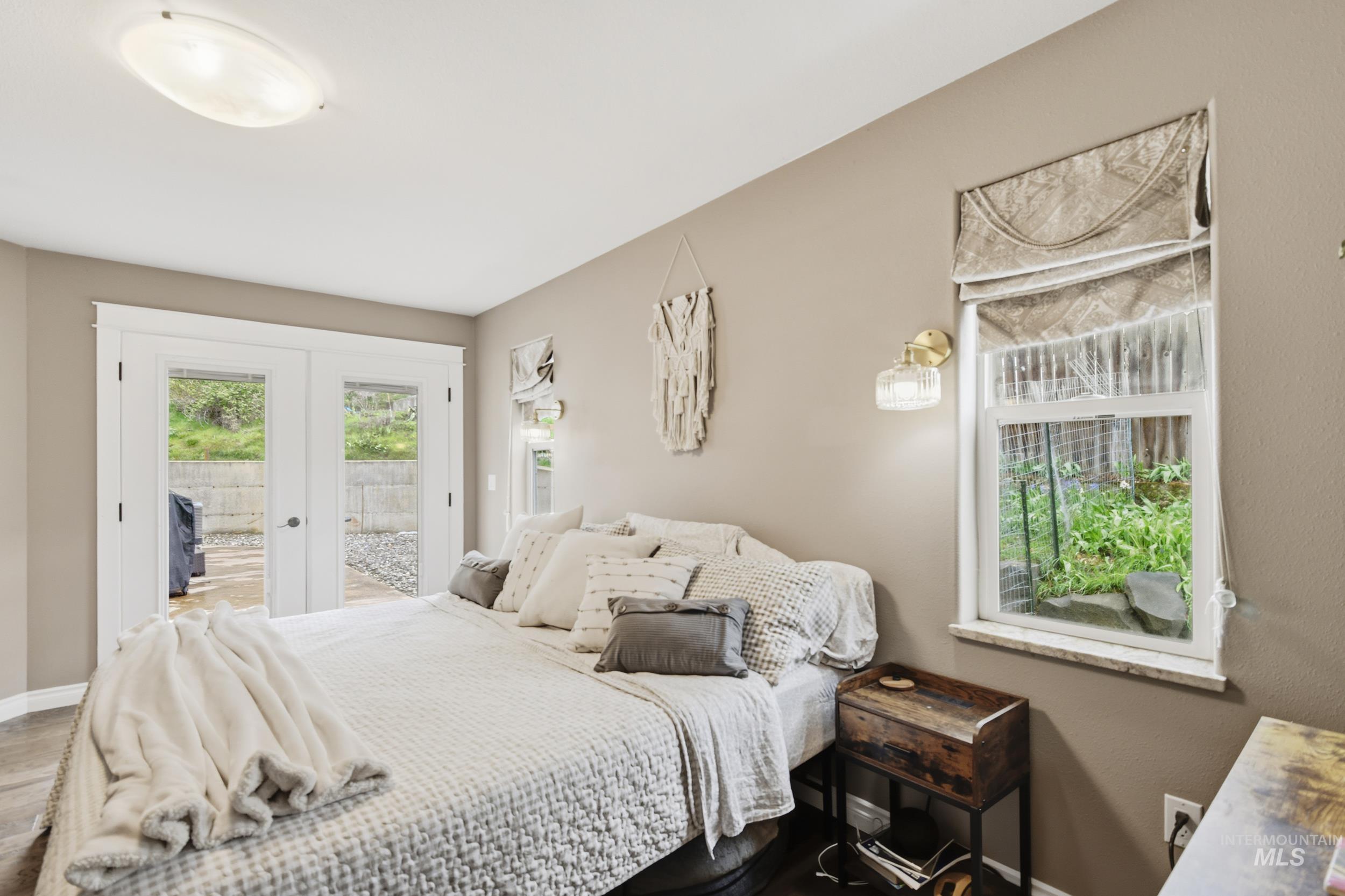 301 State Street Juliaetta, ID 83535 - Photo 22 of 41 Bedroom featuring french doors, access to outside, and wood finished floors