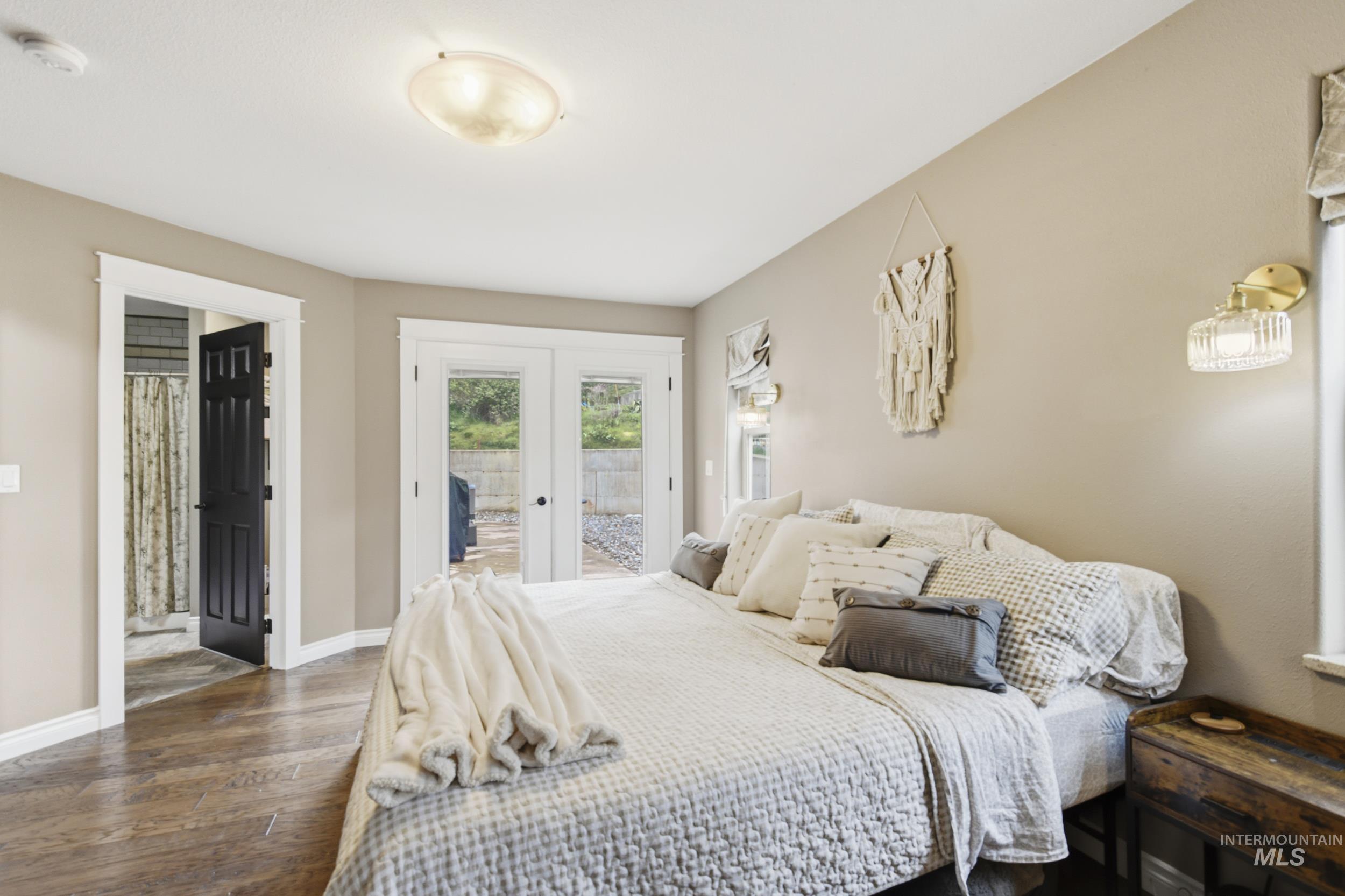 301 State Street Juliaetta, ID 83535 - Photo 23 of 41 Bedroom with french doors, access to outside, hardwood / wood-style floors, and ensuite bathroom