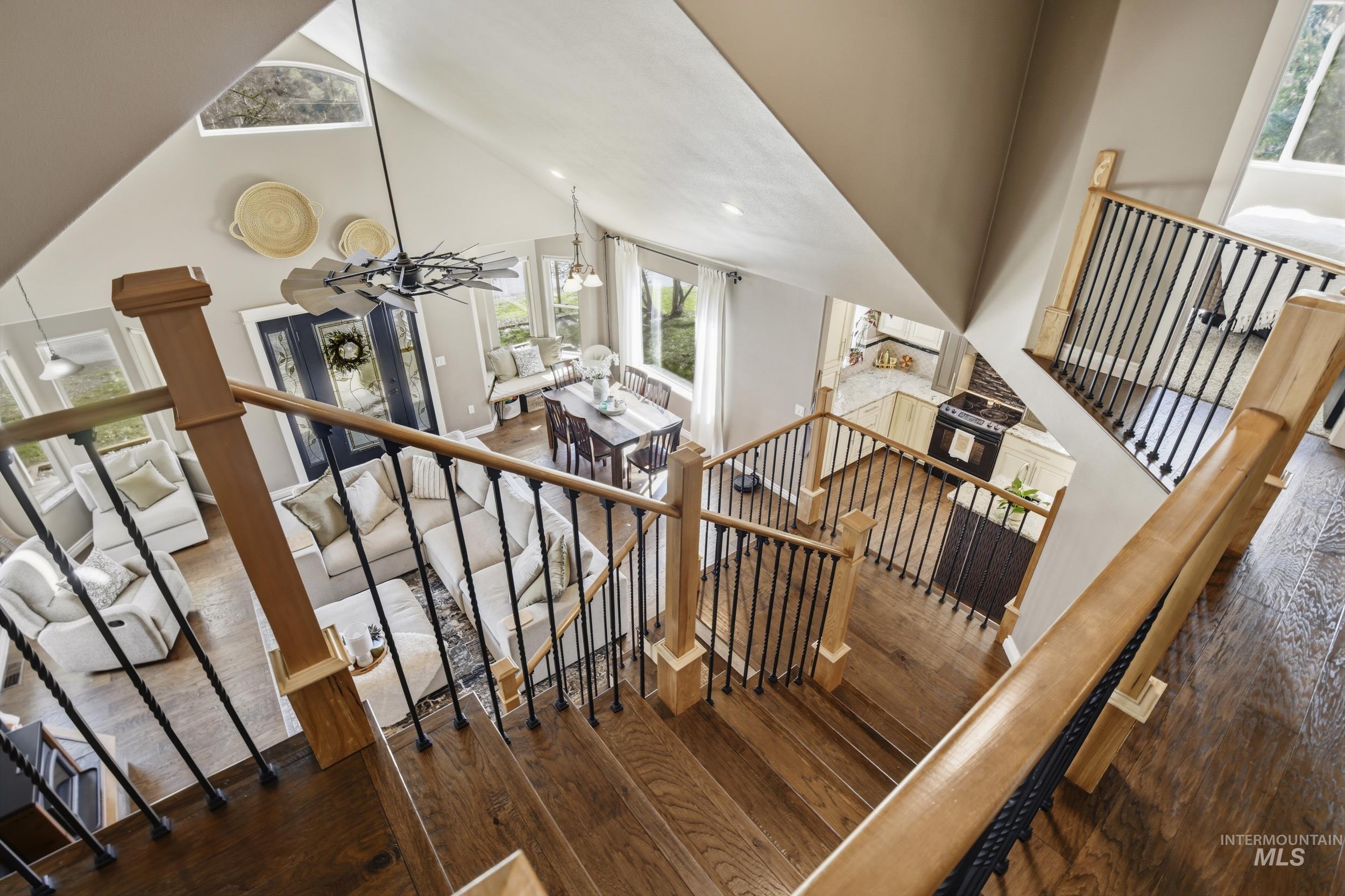 301 State Street Juliaetta, ID 83535 - Photo 26 of 41 Stairs with a high ceiling, hardwood / wood-style flooring, and suspended lighting