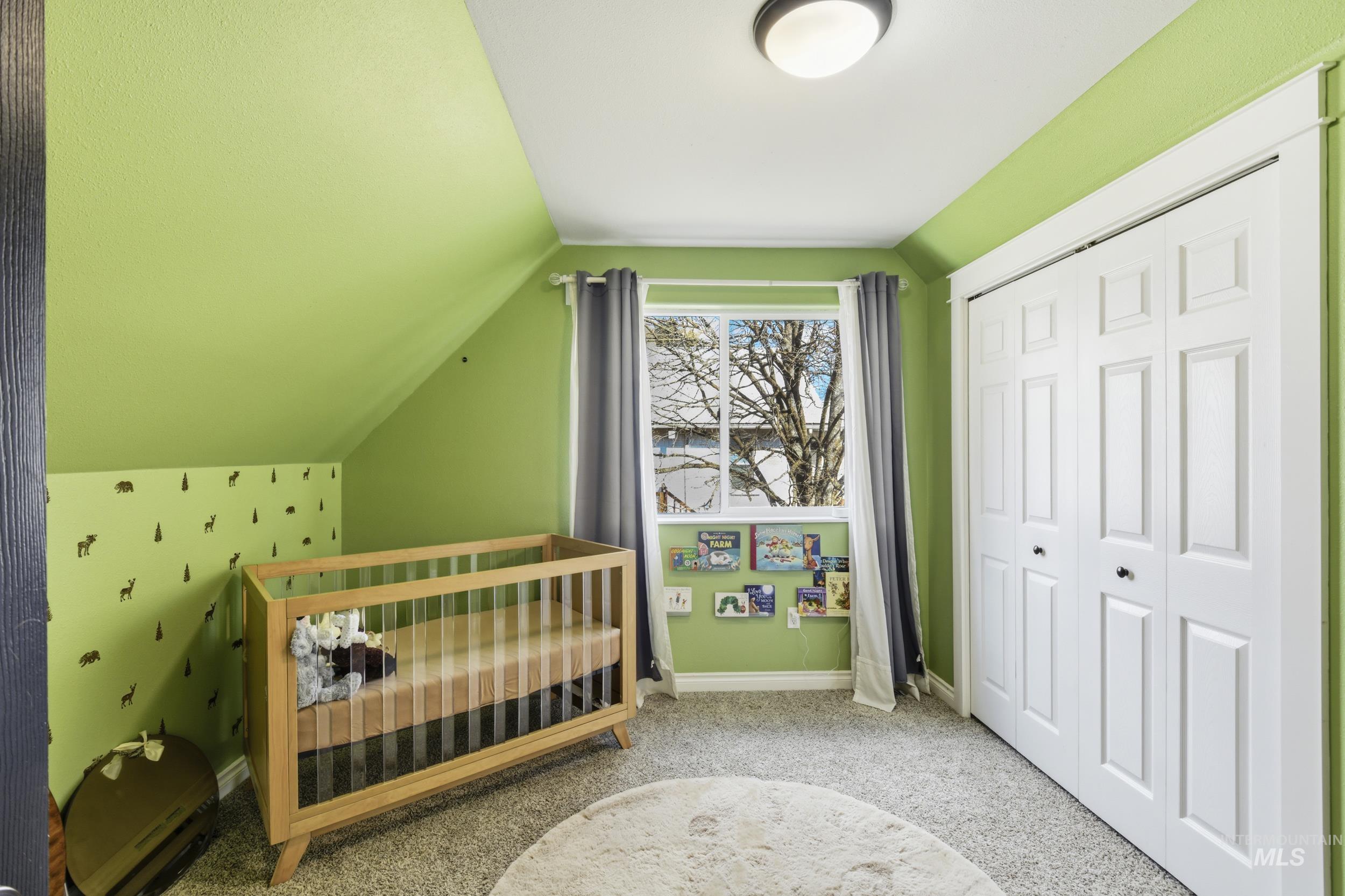 301 State Street Juliaetta, ID 83535 - Photo 27 of 41 Bedroom with vaulted ceiling, a closet, and light colored carpet