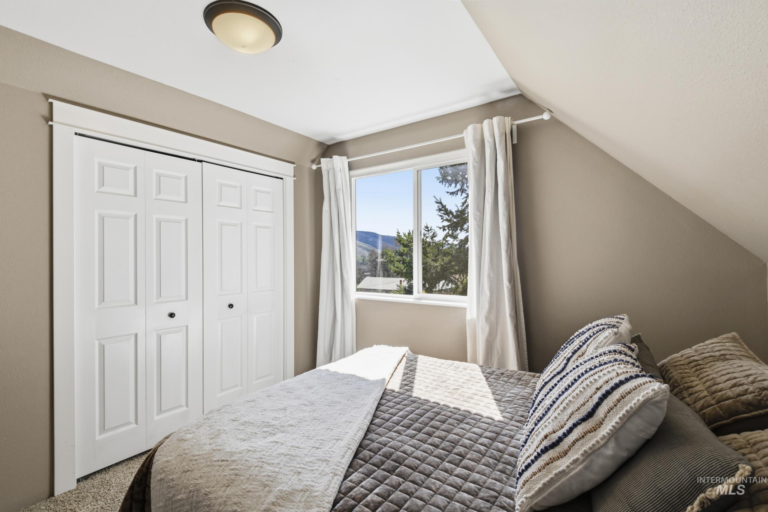 301 State Street Juliaetta, ID 83535 - Photo 29 of 41 Carpeted bedroom with vaulted ceiling and a closet