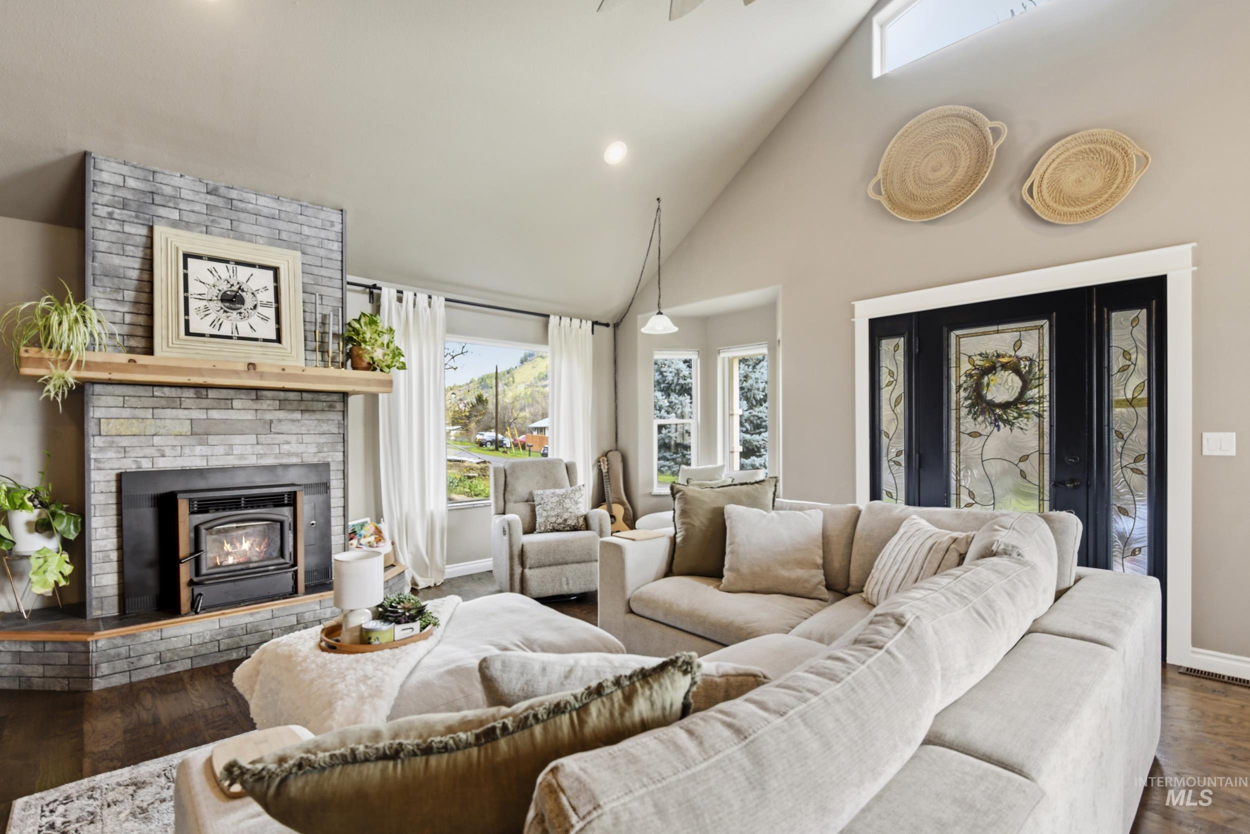 301 State Street Juliaetta, ID 83535 - Photo 8 of 41 Living area with hardwood / wood-style flooring, lofted ceiling, recessed lighting, and a brick fireplace