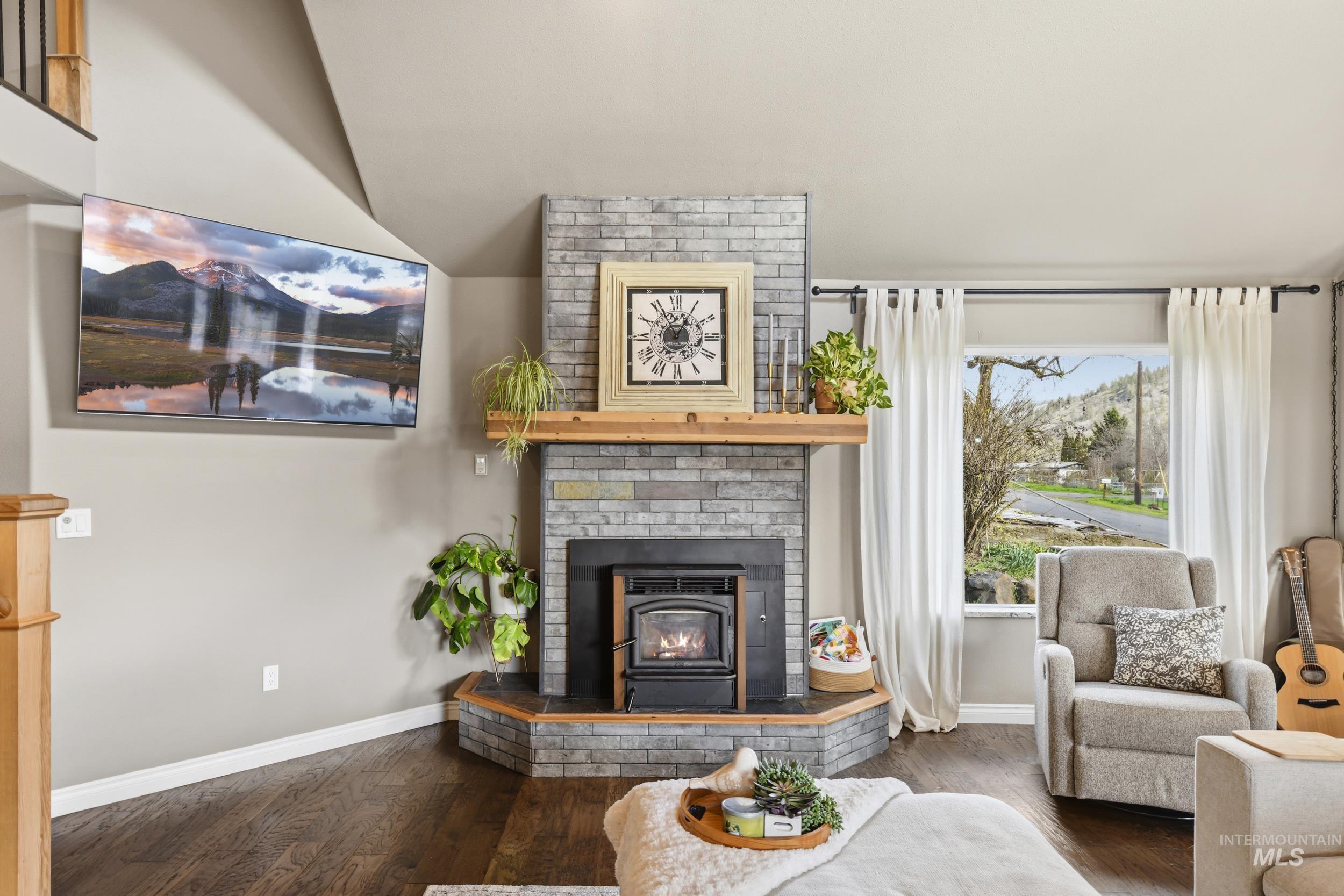 301 State Street Juliaetta, ID 83535 - Photo 10 of 41 Living area featuring dark wood-type flooring and baseboards