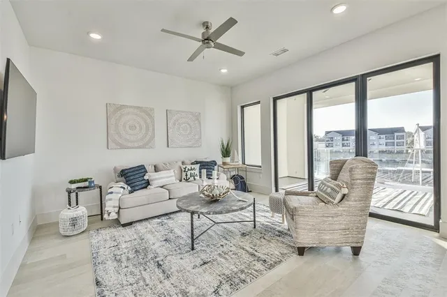 a living room with furniture and large windows