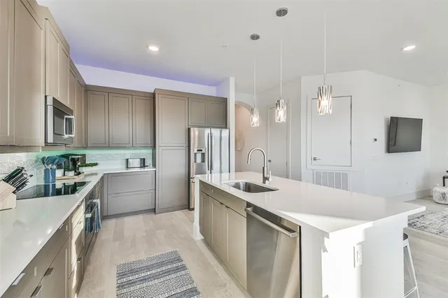 a kitchen with a sink a stove a refrigerator and a oven