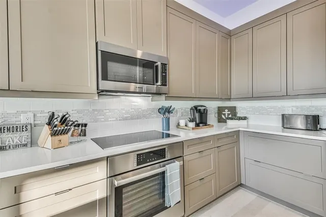 a kitchen with white cabinets and white appliances
