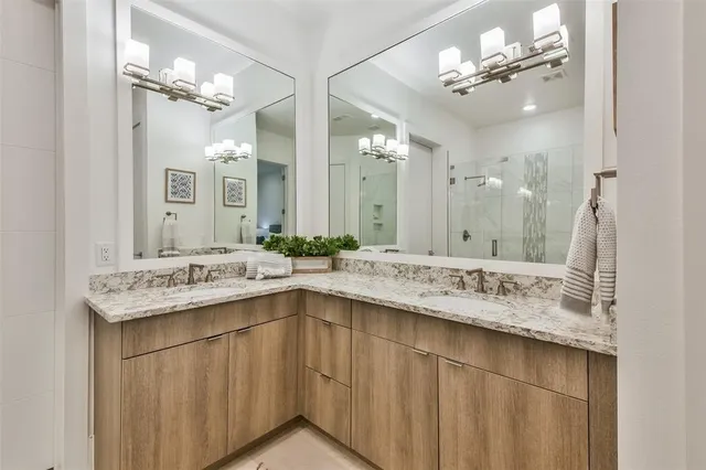 a bathroom with a sink double vanity and a mirror