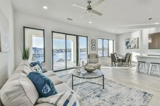 a living room with furniture and large windows