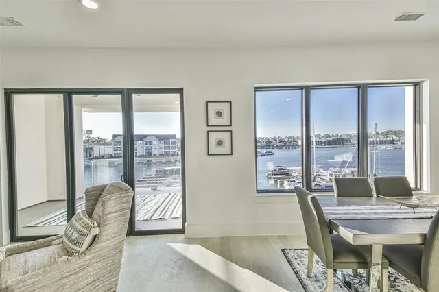 a living room with furniture and a floor to ceiling window