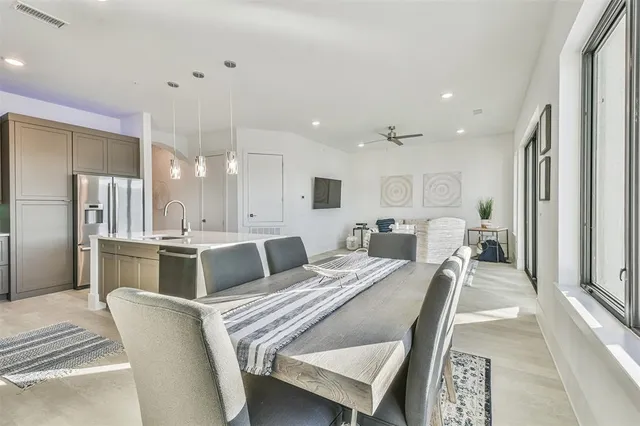a large bedroom with a bed and a view of kitchen