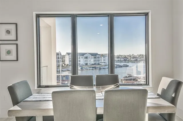 a view of a dining room with furniture and a window