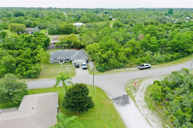 an aerial view of a house with a yard and garden