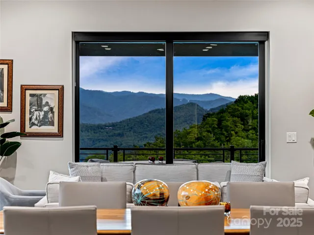 a view of living room with furniture and a floor to ceiling window