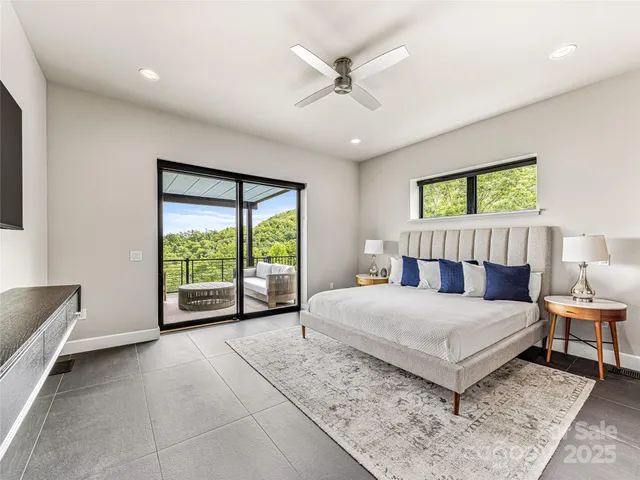 a bedroom with a large bed and a large window