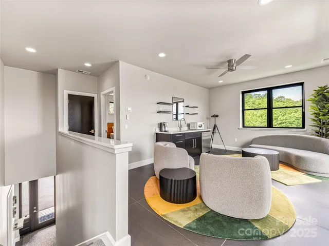a living room with furniture a window and a chandelier