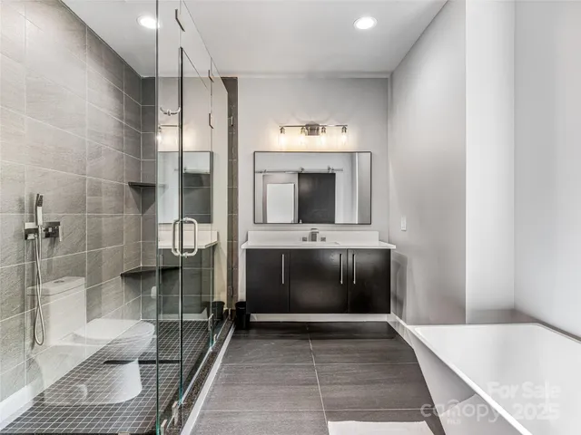 a living room with furniture a rug and a view of kitchen