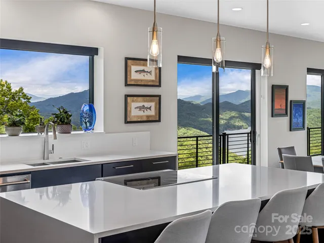 a living room with stainless steel appliances kitchen island granite countertop furniture and a large window