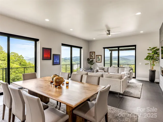 a view of a dining room with furniture large windows and wooden floor