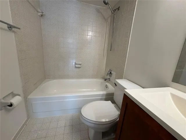 a bathroom with a sink a toilet and bathtub