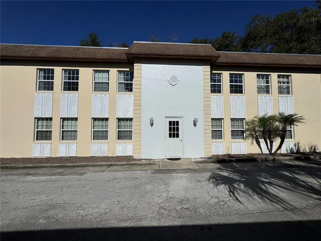 a view of a white building with large windows