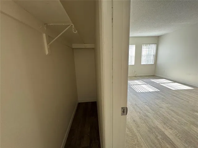 a view of an empty room and wooden floor