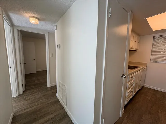 a view of a kitchen from the hallway