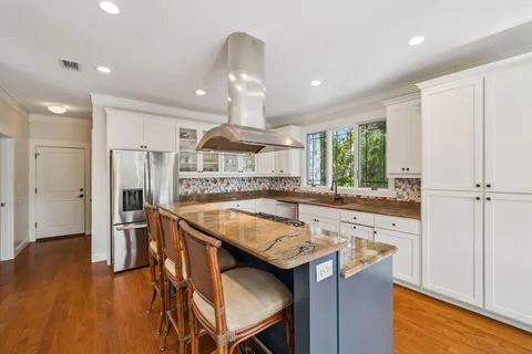 a dining room with furniture window and wooden floor