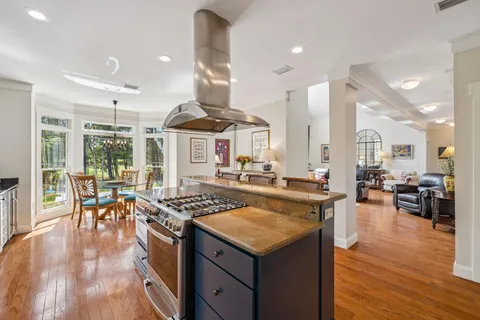 a view of a dining room with furniture a chandelier and wooden floor