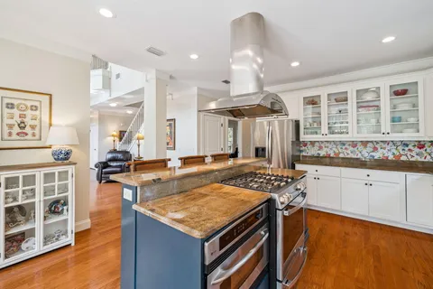 a living room with furniture and floor to ceiling windows