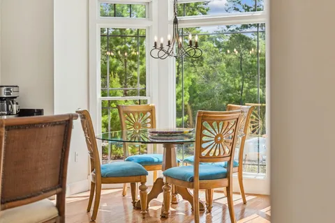 a bedroom with a large window and swimming pool