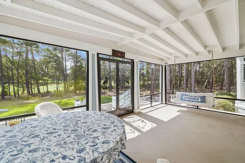 a view of a patio with table and chairs and potted plants