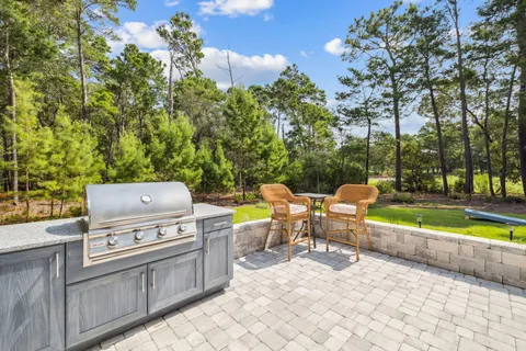 a bedroom with a bed a window and a chandelier
