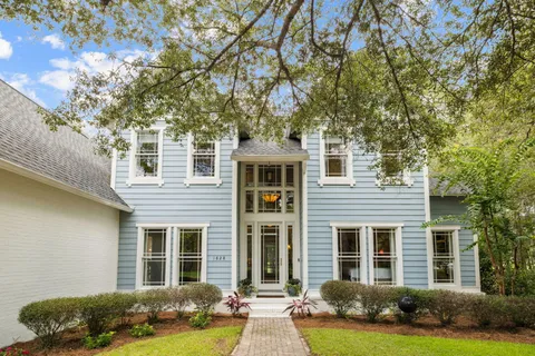 a living room with furniture and a flat screen tv with wooden floor