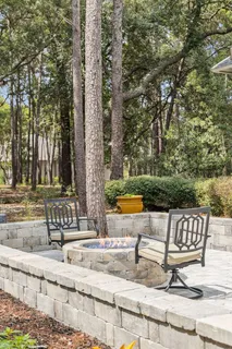 a bathroom with a granite countertop double vanity sink mirror and toilet