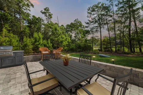 a bedroom with a bed and a flat tv screen on dresser