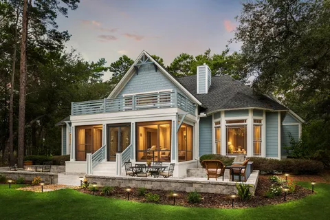 a view of a hallway with wooden floor and stairs