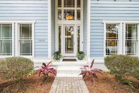 a living room with furniture fireplace and a flat screen tv